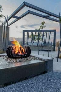 Contemporary garden with fire pit, water feature and pergola